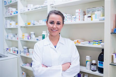 Portrait of a smiling student in lab coat with arms crossed in the pharmacy Stock Photo - Budget Royalty-Free & Subscription, Code: 400-07941526