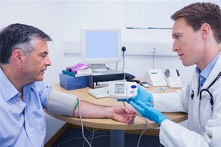 Doctor talking to his patient about his blood pressure at the hospital Stock Photo - Budget Royalty-Free & Subscription, Code: 400-07941573