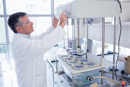 Scientist with safety glasses using the machine in laboratory Stock Photo - Budget Royalty-Free & Subscription, Code: 400-07941689