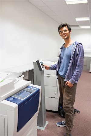 person photocopy - Smiling student standing next to the photocopier at the university Stock Photo - Budget Royalty-Free & Subscription, Code: 400-07941785