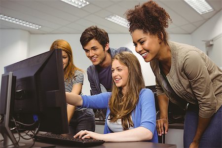 simsearch:400-07267978,k - Cheerful student pointing at computer in computer room Stock Photo - Budget Royalty-Free & Subscription, Code: 400-07941817