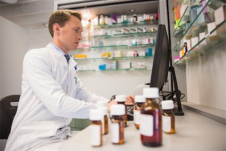 pharmacist (male) - Pharmacist using computer at desk at the hospital pharmacy Stock Photo - Budget Royalty-Free & Subscription, Code: 400-07941917
