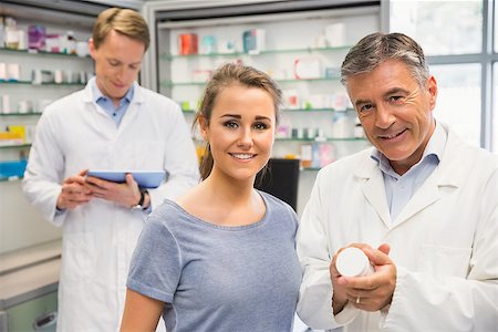 pharmacist talking client - Happy customer talking with pharmacist at the hospital pharmacy Stock Photo - Budget Royalty-Free & Subscription, Code: 400-07942004