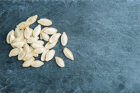 simsearch:400-07956836,k - Closeup on pumpkin seeds on stone substrate Foto de stock - Royalty-Free Super Valor e Assinatura, Número: 400-07954059