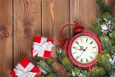 Christmas wooden background with clock, gift boxes, snow fir tree and copy space Stock Photo - Budget Royalty-Free & Subscription, Code: 400-07954106