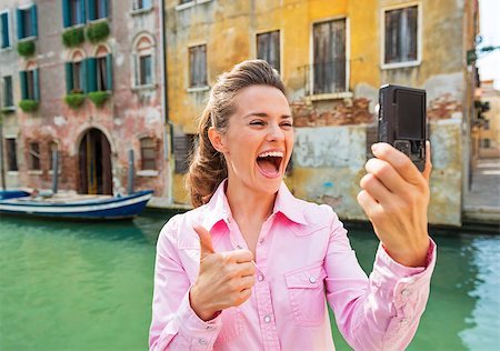 Happy young woman showing thumbs up and making selfie in venice, italy Stock Photo - Budget Royalty-Free & Subscription, Code: 400-07954260