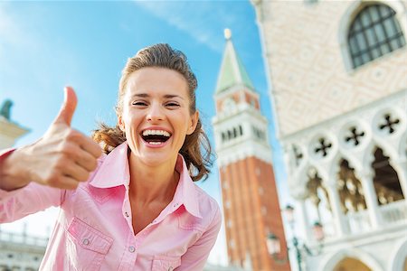 Happy young woman against campanile di san marco showing thumbs up in venice, italy Stock Photo - Budget Royalty-Free & Subscription, Code: 400-07954309