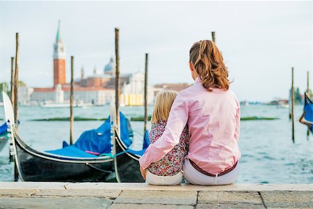 simsearch:400-07954318,k - Portrait of mother and baby sitting on grand canal embankment in venice, italy. rear view Stock Photo - Budget Royalty-Free & Subscription, Code: 400-07954326