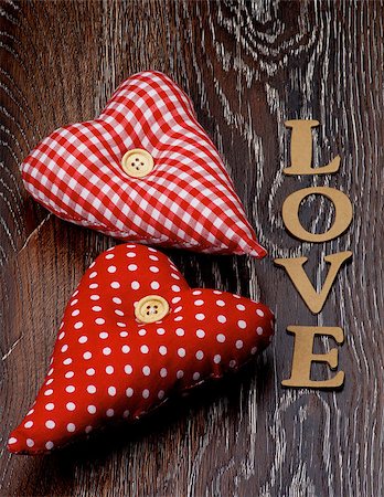 simsearch:400-07954156,k - Arrangement of Two Handmade Textile Red Polka Dot Hearts and Cardboard Word Love closeup on Dark Wooden background Foto de stock - Royalty-Free Super Valor e Assinatura, Número: 400-07954916