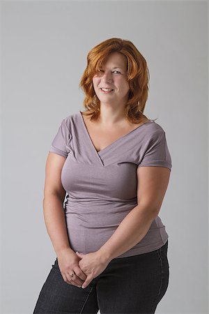 senior woman overweight - woman in her forties against a gray background Stock Photo - Budget Royalty-Free & Subscription, Code: 400-07955061