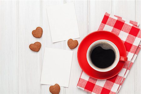 Valentines day blank photo frames, coffee cup and heart shaped cookies over white wooden table Stock Photo - Budget Royalty-Free & Subscription, Code: 400-07955452