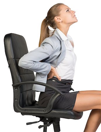 Businesswoman with lower back pain from sitting on office chair. Isolated over white background Stockbilder - Microstock & Abonnement, Bildnummer: 400-07955580