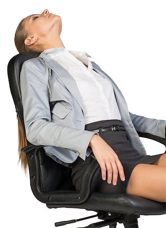 Businesswoman resting in office chair with her head thrown back, her eyes closed, her arms on armrests. Isolated over white background Stock Photo - Budget Royalty-Free & Subscription, Code: 400-07955582