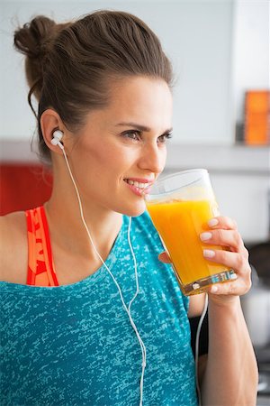smoothie sports - Happy fitness young woman drinking pumpkin smoothie Stock Photo - Budget Royalty-Free & Subscription, Code: 400-07955813