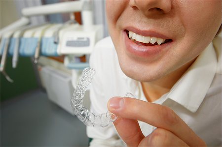 smile teeth braces - Close-up shot of man with big smile holding mouth guard or orthodontic retainers in dental office Stock Photo - Budget Royalty-Free & Subscription, Code: 400-07955854