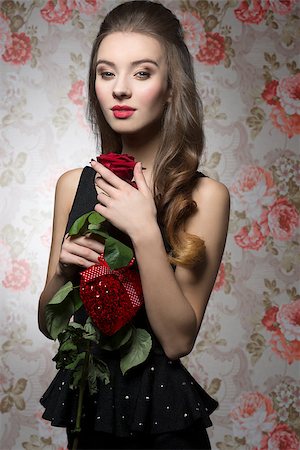 simsearch:400-07986693,k - Young, beautiful, bright, elegant girl in black dress is holding valentines present like rose and heart. Her makeup is perfect. Stock Photo - Budget Royalty-Free & Subscription, Code: 400-07955866
