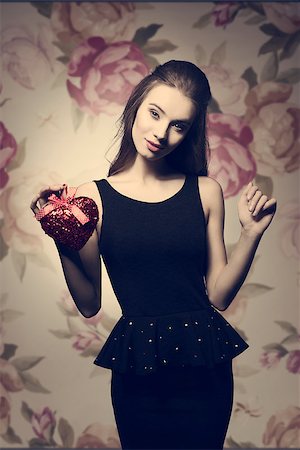simsearch:400-07986693,k - Young, beautiful, stylish, elegant girl in black dess is holding valentine's present. Her make up is prefect. Stock Photo - Budget Royalty-Free & Subscription, Code: 400-07955868
