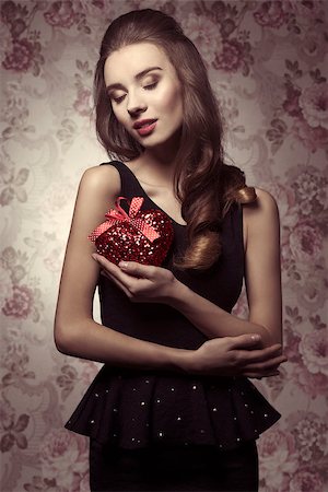 simsearch:400-07986693,k - Beautiful, young, brunette with nice hairstyle is ready for valentine's day. She has got black dress and perfect make up. Stock Photo - Budget Royalty-Free & Subscription, Code: 400-07955869