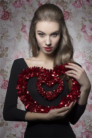 simsearch:400-07986693,k - Pretty, young, attractive valentines girl with brown curly hair and brown make up is holding a heart. Stock Photo - Budget Royalty-Free & Subscription, Code: 400-07955878