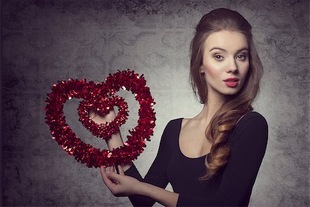 simsearch:400-07986693,k - Young, fresh, romantic, pretty valentine girl with nice hairstyle and makeup is holding a heart. Stock Photo - Budget Royalty-Free & Subscription, Code: 400-07955879