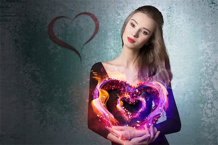 simsearch:400-07986693,k - Young, beautiful, romantic valentines girl with curly hairstyle and with valentine heart.She wears black top and brown makeup. Stock Photo - Budget Royalty-Free & Subscription, Code: 400-07955880