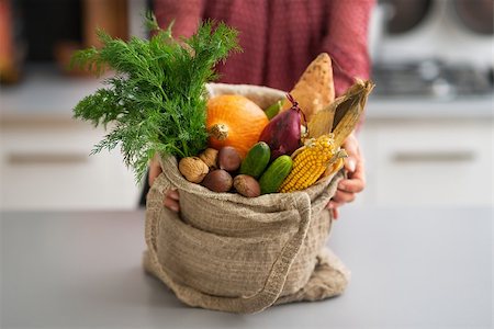 shopping bags in kitchen - Closeup on young housewife showing fresh vegetables in shopping bag from local market Stock Photo - Budget Royalty-Free & Subscription, Code: 400-07955971