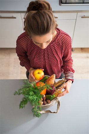 shopping bags in kitchen - Young housewife sort purchases after shopping on local market Stock Photo - Budget Royalty-Free & Subscription, Code: 400-07955985