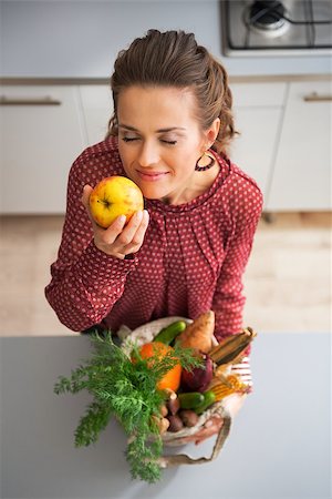 Happy young housewife enjoying freshness of purchases from local market Stock Photo - Budget Royalty-Free & Subscription, Code: 400-07955983