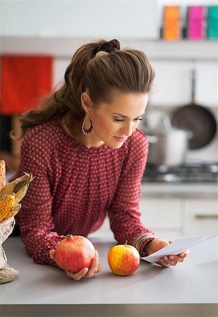 shopping bags in kitchen - Young housewife exploring checks after grocery shopping in kitchen Stock Photo - Budget Royalty-Free & Subscription, Code: 400-07955990