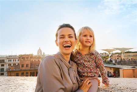 simsearch:400-07956611,k - Portrait of happy mother and baby girl on street overlooking rooftops of rome on sunset Foto de stock - Royalty-Free Super Valor e Assinatura, Número: 400-07956180