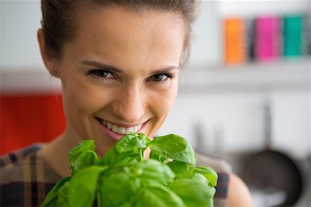 simsearch:400-07956886,k - Portrait of happy young housewife with fresh basil Photographie de stock - Aubaine LD & Abonnement, Code: 400-07956324