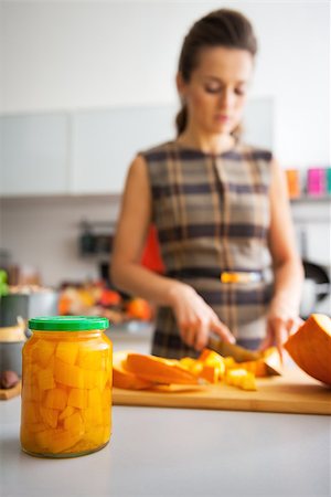 simsearch:400-07956018,k - Closeup on jar of pickled pumpkin and young housewife cutting in background Stockbilder - Microstock & Abonnement, Bildnummer: 400-07956558