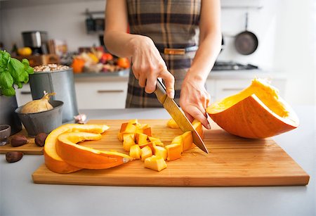 Closeup on young housewife cutting pumpkin Stock Photo - Budget Royalty-Free & Subscription, Code: 400-07956559