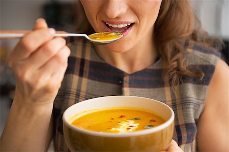 pumpkin soup - Closeup on young woman eating pumpkin soup in kitchen Stock Photo - Budget Royalty-Free & Subscription, Code: 400-07956587