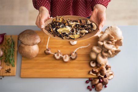 Closeup on young housewife showing mushrooms Stock Photo - Budget Royalty-Free & Subscription, Code: 400-07956797