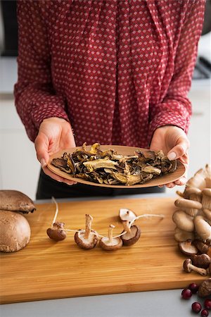 simsearch:400-05305223,k - Closeup on young housewife showing dried mushrooms Stock Photo - Budget Royalty-Free & Subscription, Code: 400-07956793
