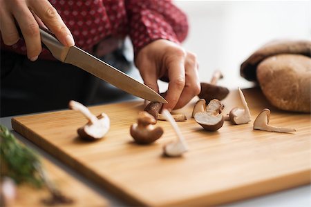 simsearch:400-07217319,k - Closeup on young housewife cutting mushrooms in kitchen Stock Photo - Budget Royalty-Free & Subscription, Code: 400-07956804