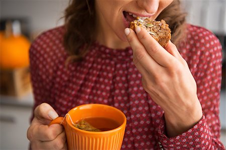 Closeup on young housewife drinking tea with freshly baked pumpkin bread with seeds Stock Photo - Budget Royalty-Free & Subscription, Code: 400-07956864