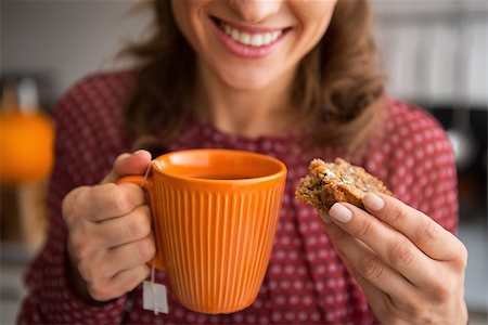 drinking healthy tea - Closeup on young housewife drinking tea with freshly baked pumpkin bread with seeds Stock Photo - Budget Royalty-Free & Subscription, Code: 400-07956863