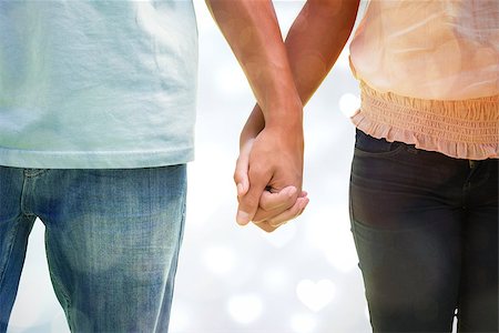 Young couple holding hands in the park against valentines heart design Stock Photo - Budget Royalty-Free & Subscription, Code: 400-07957006