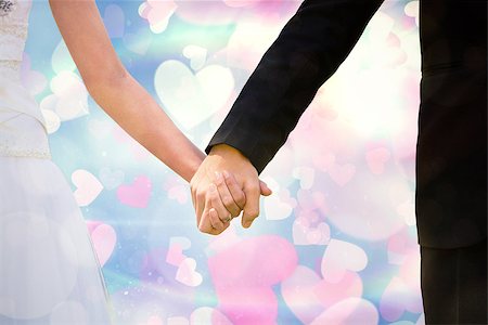 simsearch:400-07957006,k - Mid section of newlywed couple holding hands in park against valentines heart design Stock Photo - Budget Royalty-Free & Subscription, Code: 400-07957007