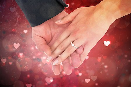 simsearch:400-07957006,k - Close-up of bride and groom with hands together against valentines heart design Stock Photo - Budget Royalty-Free & Subscription, Code: 400-07957008