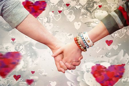 simsearch:400-07957805,k - Students holding hands against love heart pattern Photographie de stock - Aubaine LD & Abonnement, Code: 400-07957027