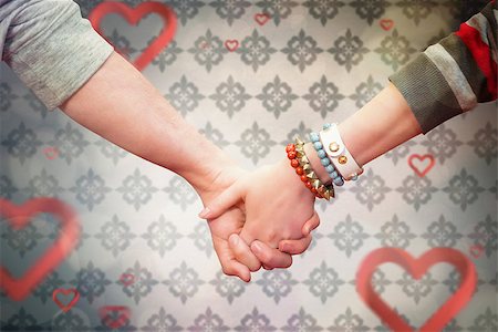 simsearch:400-07957805,k - Students holding hands against love heart pattern Photographie de stock - Aubaine LD & Abonnement, Code: 400-07957028