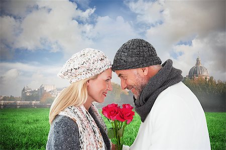 simsearch:400-07957430,k - Smiling couple in winter fashion posing with roses against paris under cloudy sky Photographie de stock - Aubaine LD & Abonnement, Code: 400-07957039