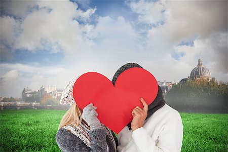 simsearch:400-07957430,k - Couple in winter fashion posing with heart shape against paris under cloudy sky Photographie de stock - Aubaine LD & Abonnement, Code: 400-07957033