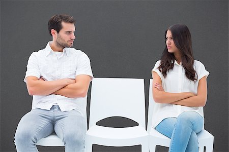 simsearch:400-06687238,k - Angry couple not talking after argument against grey Fotografie stock - Microstock e Abbonamento, Codice: 400-07957095