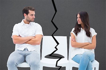 simsearch:400-06687238,k - Angry couple not talking after argument against grey Fotografie stock - Microstock e Abbonamento, Codice: 400-07957106