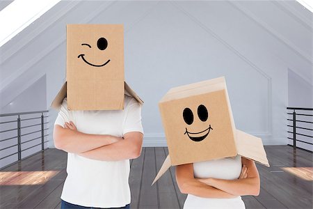 Mature couple wearing boxes over their heads against modern room Stock Photo - Budget Royalty-Free & Subscription, Code: 400-07957128