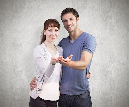 simsearch:400-07957339,k - Couple holding out their hands against weathered surface Photographie de stock - Aubaine LD & Abonnement, Code: 400-07957317